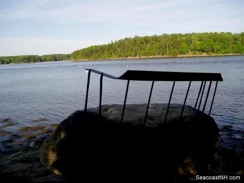 Sculptural metal chair embedded in natural boulder on Great Bay / SeacoastNH.com