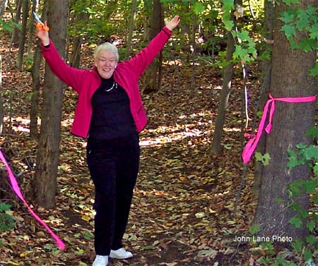 Susan Douglas Fleming, who donated the 22-acre Douglas Memorial Woods in Eliot to Great Works Regional Land Trust, celebrates the ribbon cutting ceremony for the public walking trail recently. (Courtesy photo by John Lane)